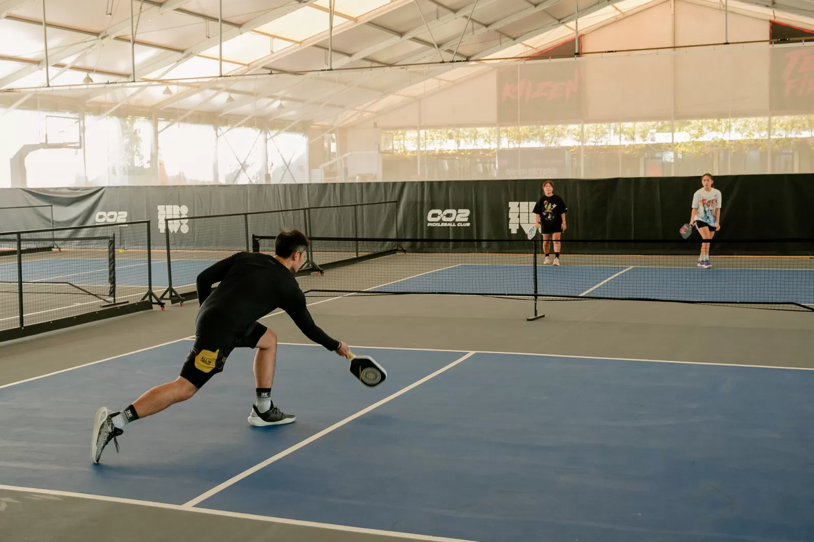 Indoor courts at Hyprground in Petaling Jaya featuring VIP lounges and view of playing area within the converted warehouse space.