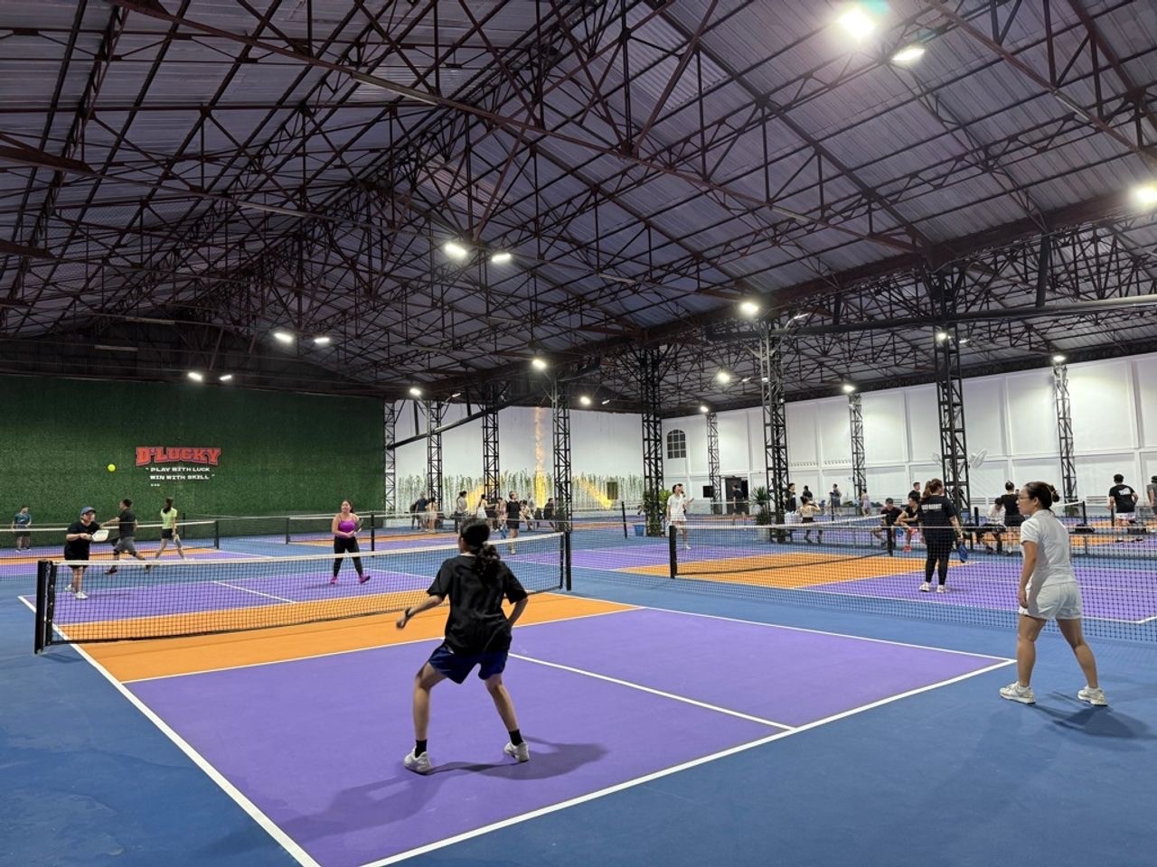 Indoor courts at Hyprground in Petaling Jaya featuring VIP lounges and view of playing area within the converted warehouse space.