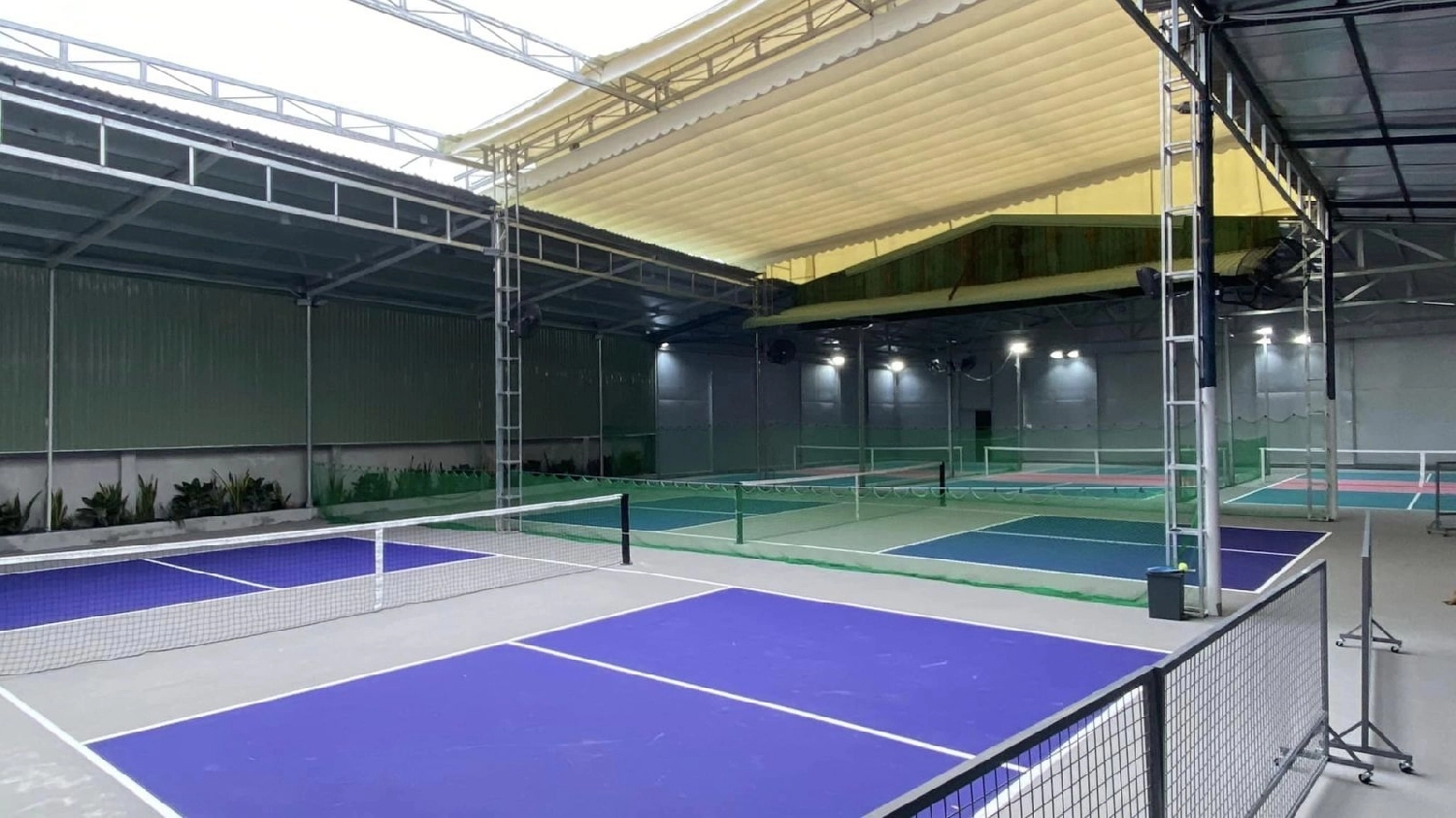 Indoor courts at Hyprground in Petaling Jaya featuring VIP lounges and view of playing area within the converted warehouse space.