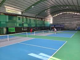 Indoor courts at Hyprground in Petaling Jaya featuring VIP lounges and view of playing area within the converted warehouse space.